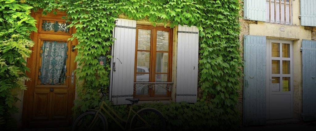 Home with green ivy and brown door